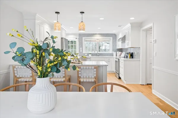 a view of living room kitchen with furniture and a potted plant