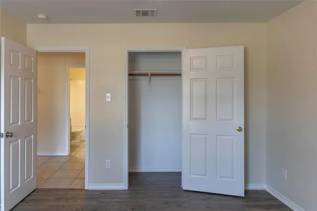 a bathroom with a granite countertop toilet a sink and bathtub