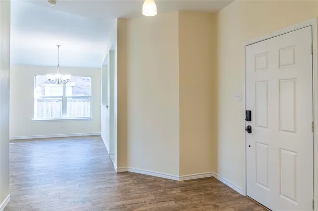 an empty room with wooden floor sink and closet