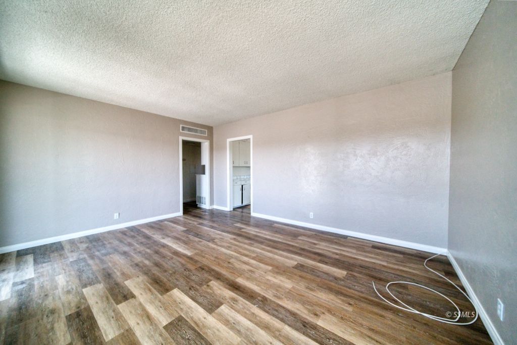 137 South Richmond Road Ridgecrest, CA 93555 - Photo 6 of 31 a view of empty room with wooden floor