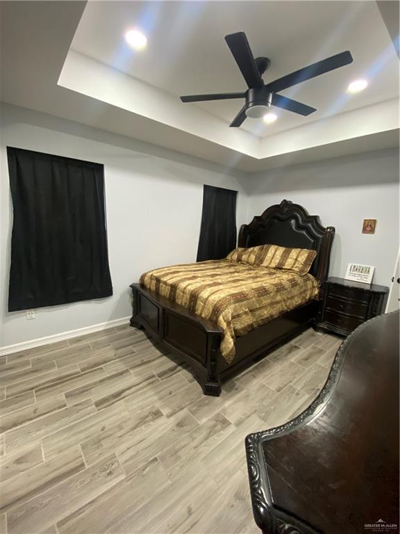 814 North Flag Street Pharr, TX 78577 - Photo 11 of 16 a bedroom with a bed and a ceiling fan