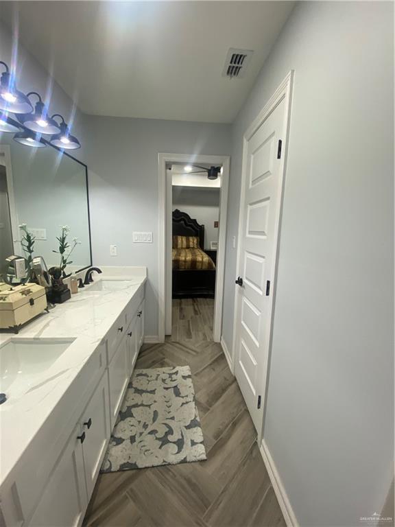 814 North Flag Street Pharr, TX 78577 - Photo 13 of 16 a bathroom with a double vanity sink and a mirror