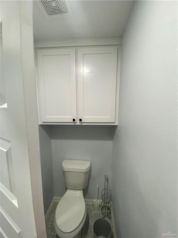 814 North Flag Street Pharr, TX 78577 - Photo 6 of 16 a bathroom with a toilet and a sink