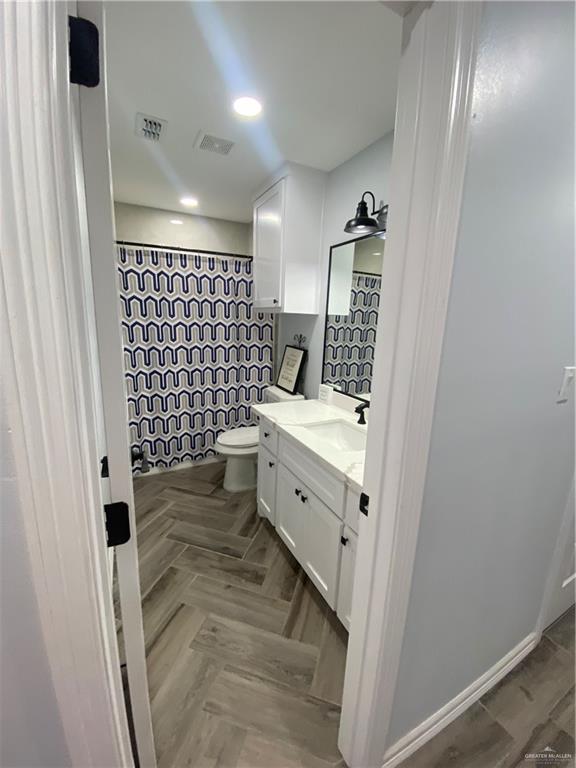 814 North Flag Street Pharr, TX 78577 - Photo 7 of 16 a bathroom with a double vanity sink toilet and shower