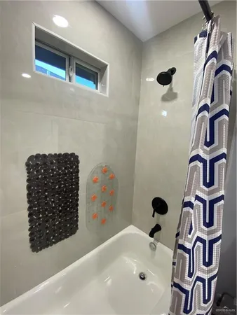 a bathroom with a bathtub and shower