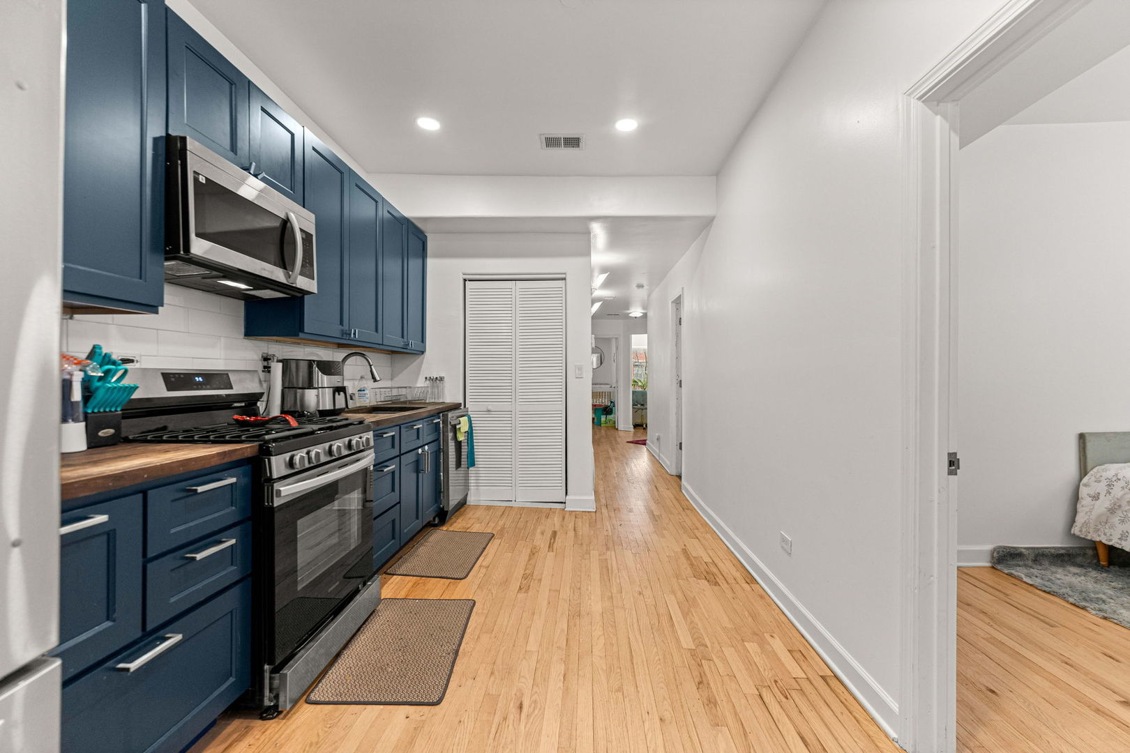 6722 South Ridgeland Avenue, Unit 3S Chicago, IL 60649 - Photo 11 of 17 a kitchen with stainless steel appliances granite countertop wooden cabinets a stove top oven a sink and dishwasher