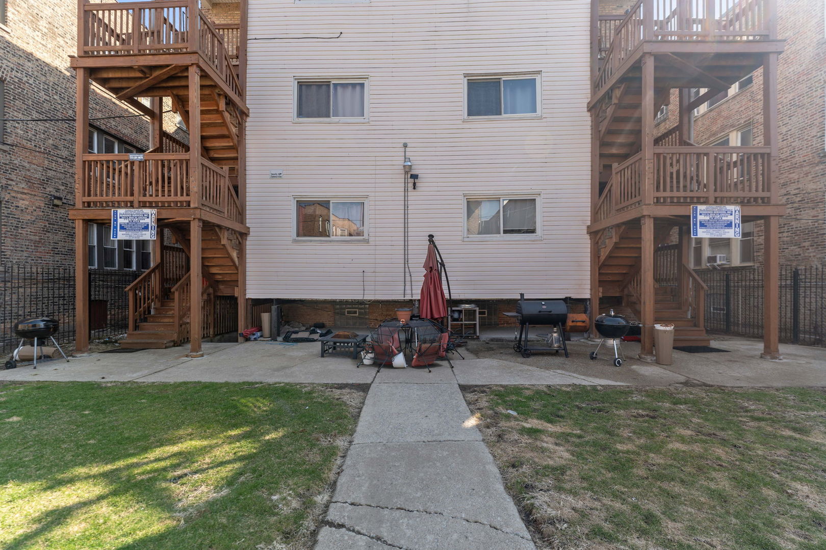 6722 South Ridgeland Avenue, Unit 3S Chicago, IL 60649 - Photo 15 of 17 a backyard of a building with glass windows and couches