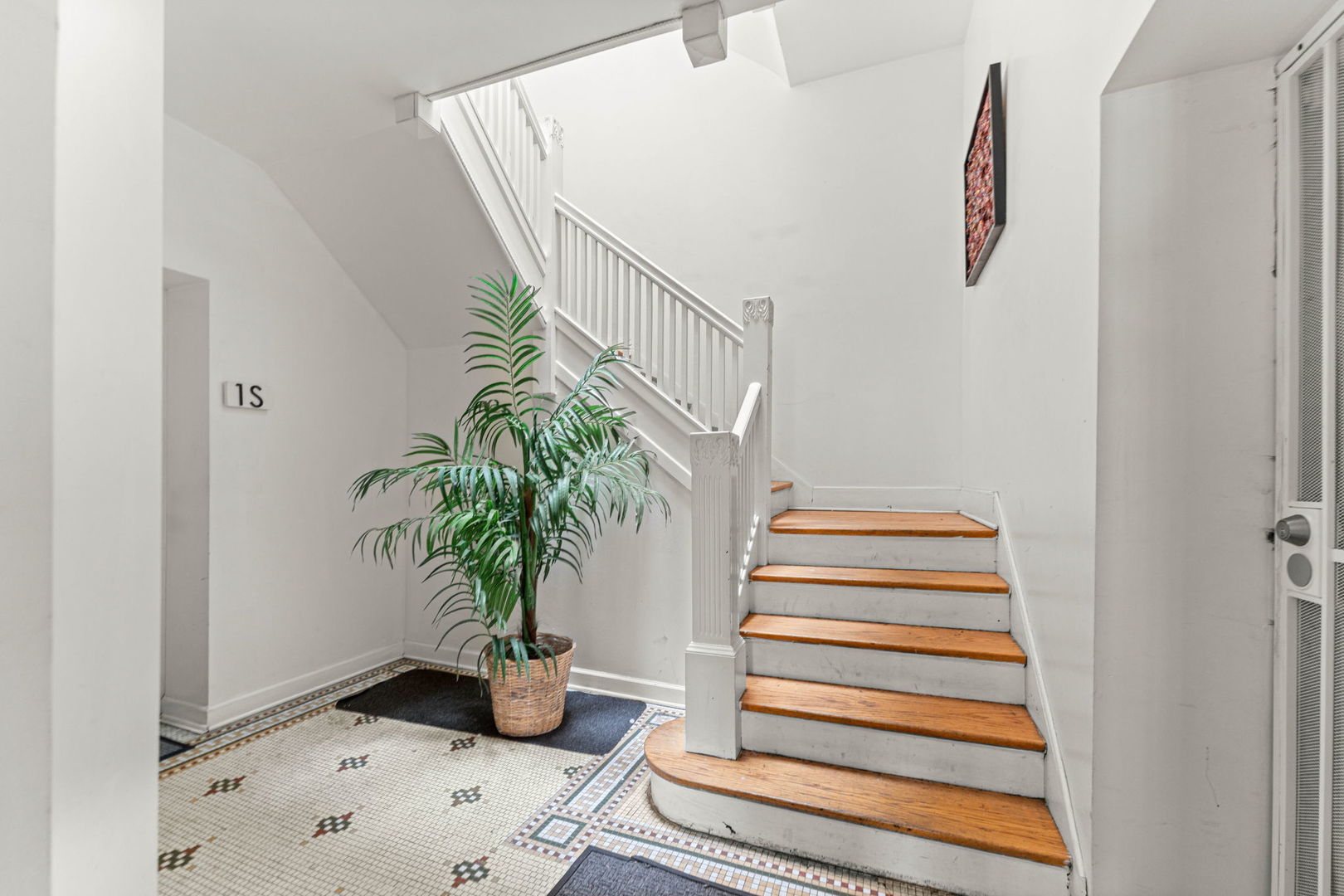 6722 South Ridgeland Avenue, Unit 3S Chicago, IL 60649 - Photo 2 of 17 a vase of flowers sitting on a floor in front of a door