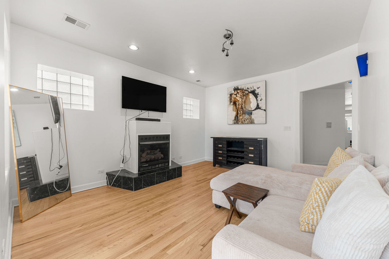 6722 South Ridgeland Avenue, Unit 3S Chicago, IL 60649 - Photo 5 of 17 a living room with furniture a fireplace and flat screen tv