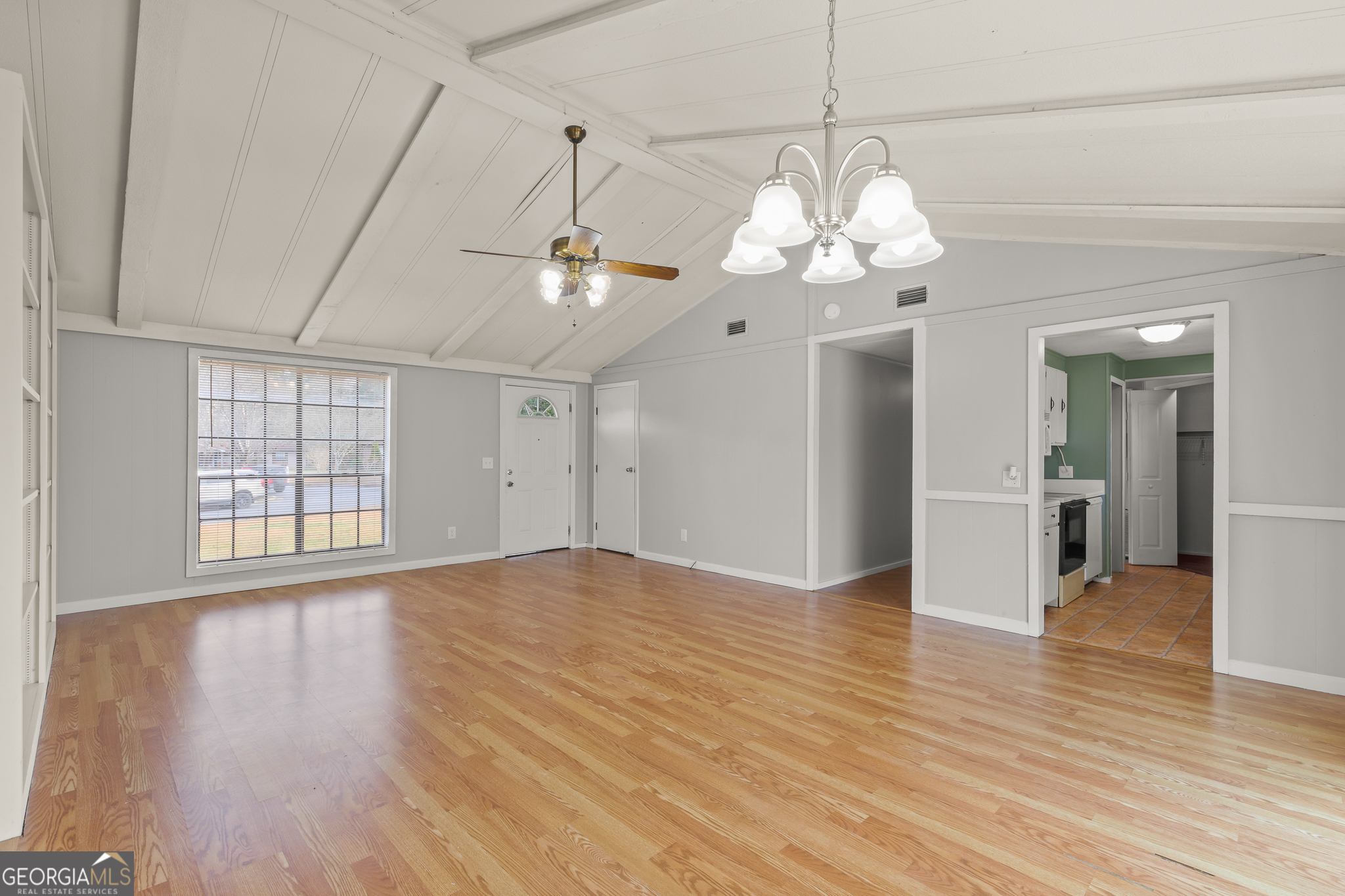 115 Valley View Court Tyrone, GA 30290 - Photo 5 of 15 a view of a livingroom with a chandelier fan and wooden floor