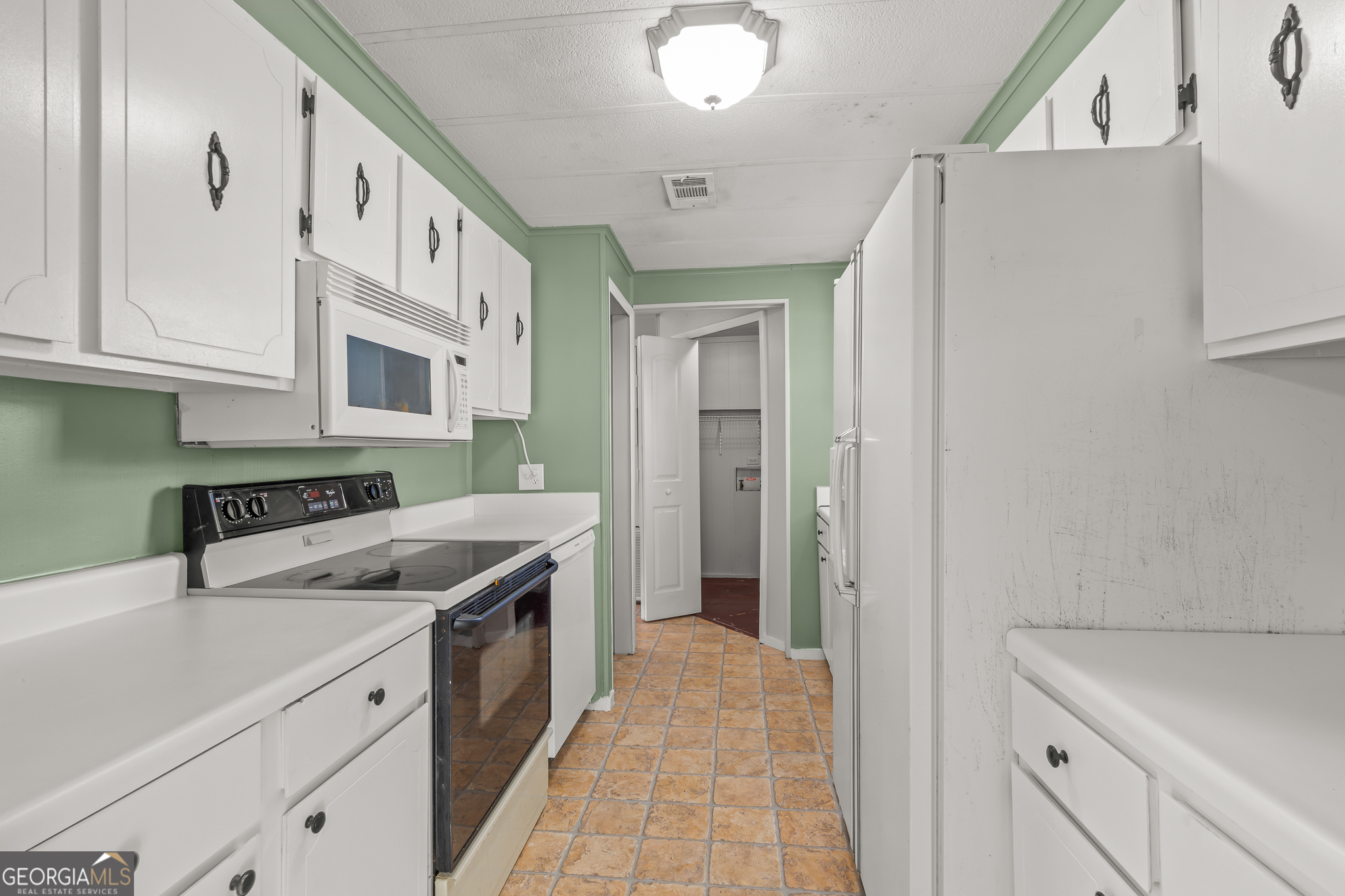 115 Valley View Court Tyrone, GA 30290 - Photo 6 of 15 a kitchen with a sink stove and refrigerator