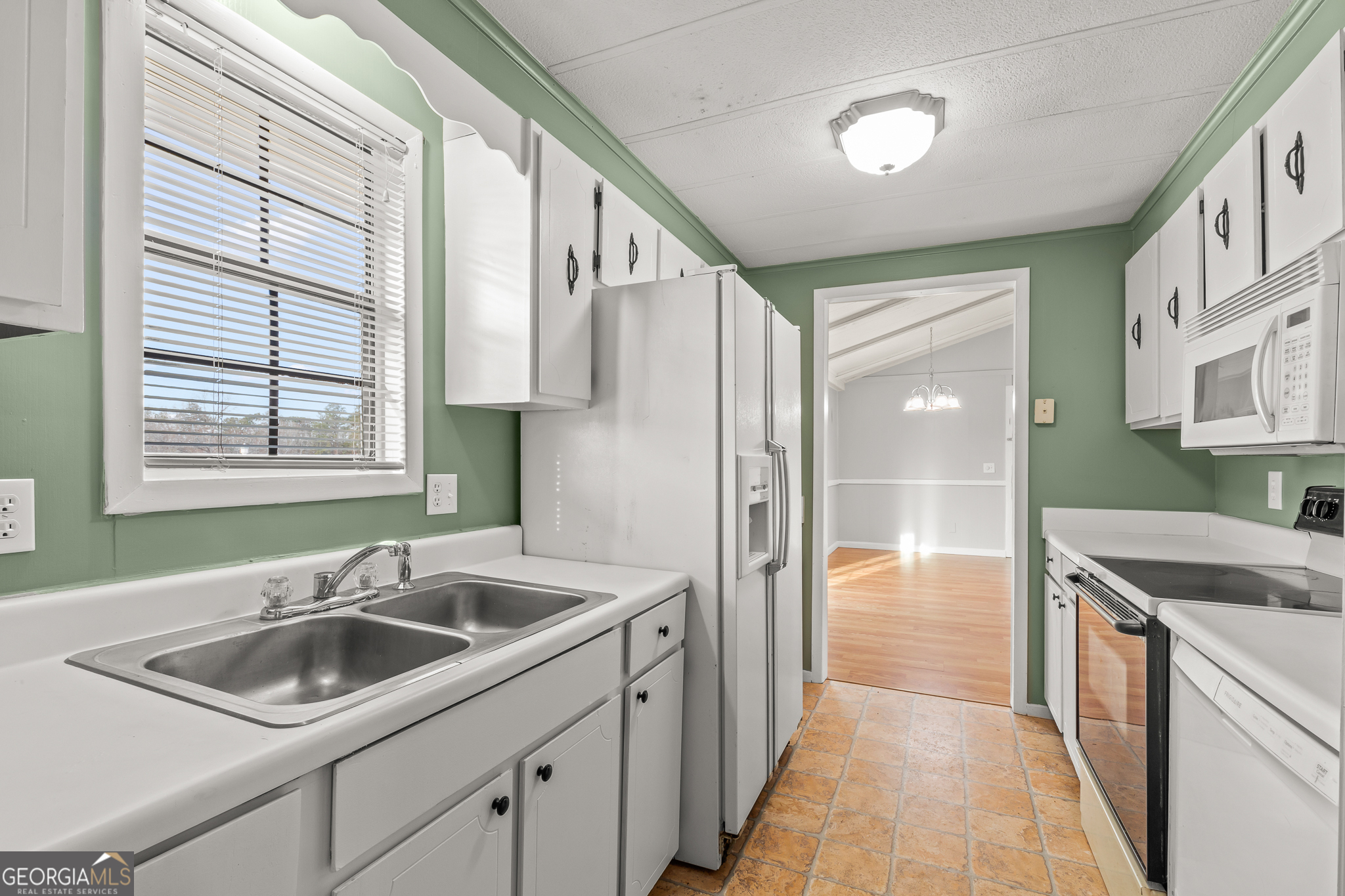 115 Valley View Court Tyrone, GA 30290 - Photo 7 of 15 a kitchen that has a sink cabinets counter space and a window