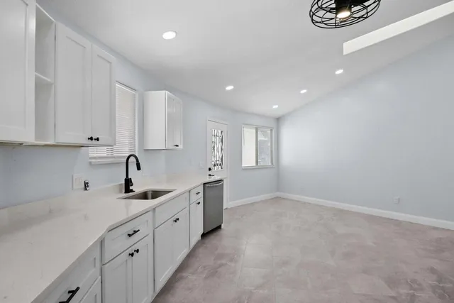 a kitchen with stainless steel appliances a sink stove and cabinets