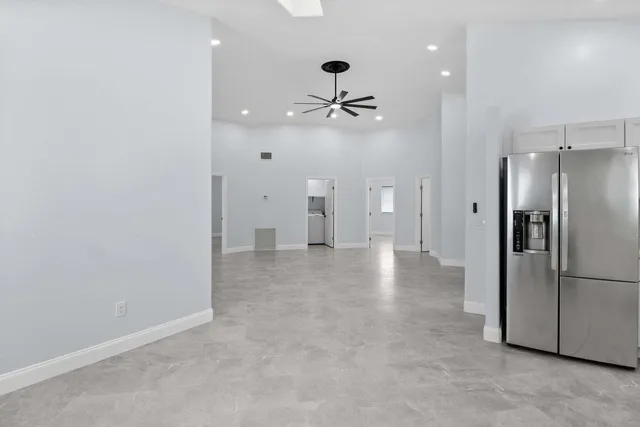 an empty room with closet and a refrigerator