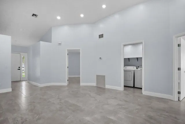 a view of a kitchen with a sink and a refrigerator