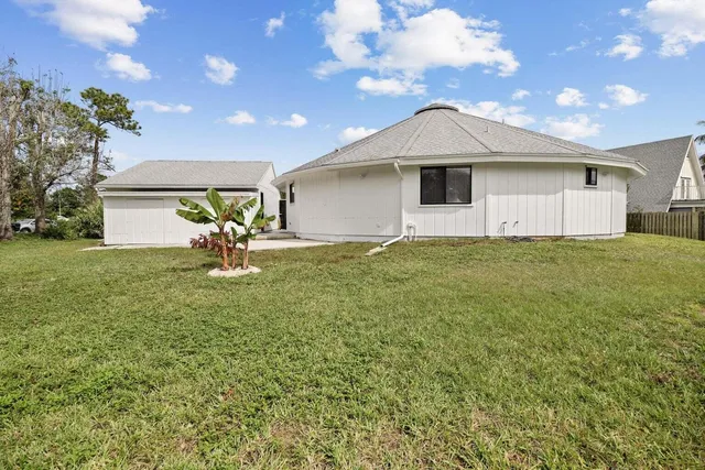 a front view of a house with a garden and yard