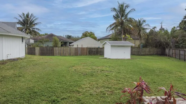 a front view of house with yard and trees