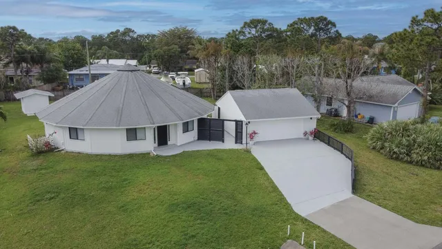 a aerial view of a house next to a yard