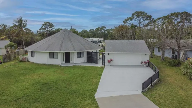 a aerial view of a house with a yard and trees