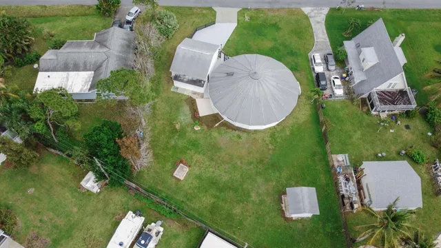 an aerial view of a house with outdoor space and lake view