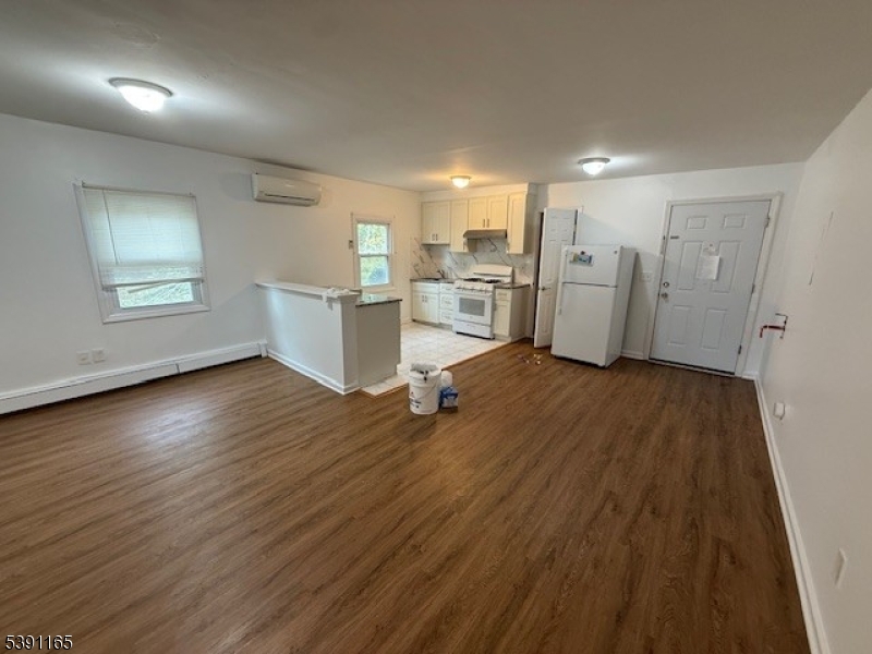 173 Highway 46, Unit L4 Mine Hill, NJ 07803 - Photo 1 of 10 a view of a kitchen with workspace and wooden floor