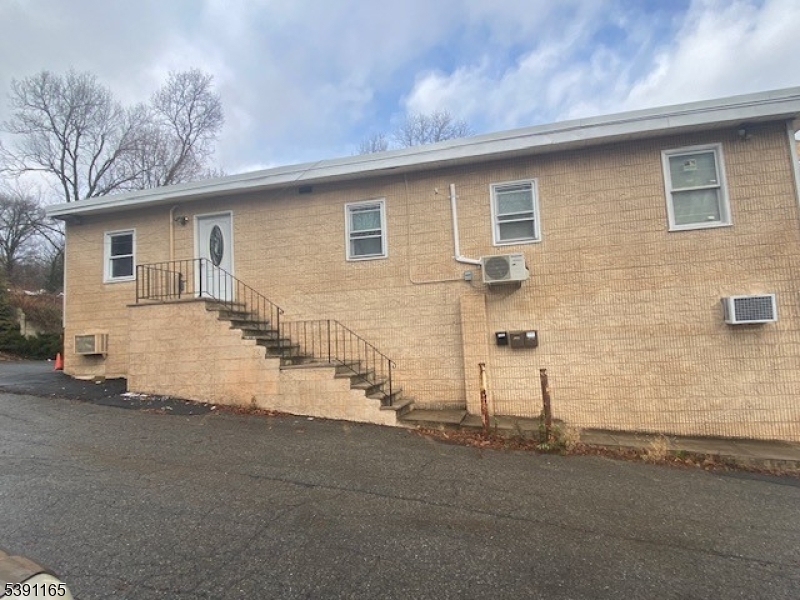 173 Highway 46, Unit L4 Mine Hill, NJ 07803 - Photo 2 of 10 a view of a house with a yard and garage