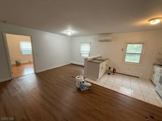 a view of a workspace with wooden floor and a window