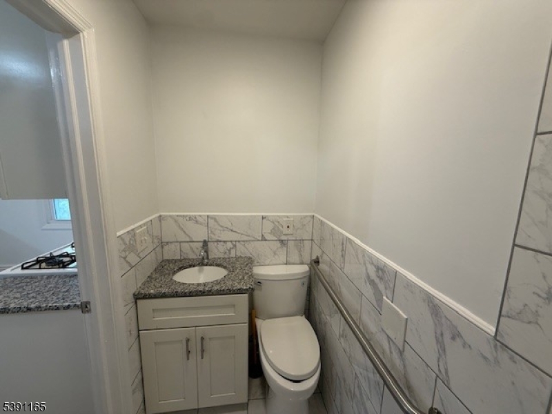 173 Highway 46, Unit L4 Mine Hill, NJ 07803 - Photo 5 of 10 a bathroom with a granite countertop toilet and a sink