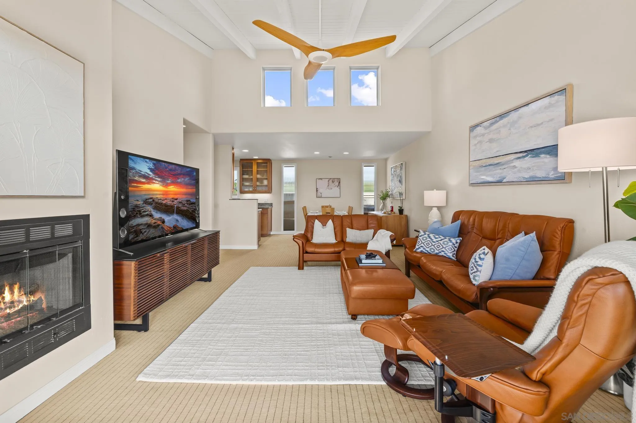 429 South Sierra Avenue, Unit 328 Solana Beach, CA 92075 - Photo 17 of 43 a living room with furniture a flat screen tv and a fireplace