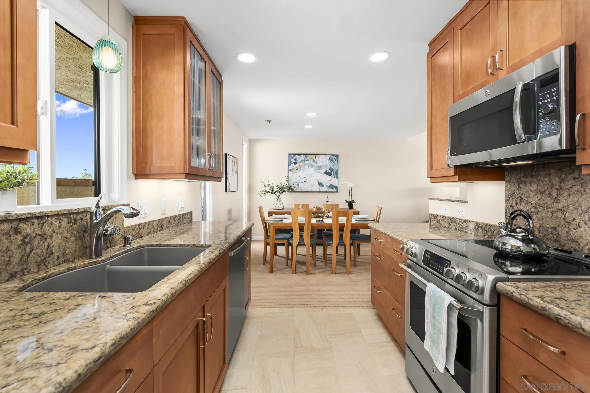 429 South Sierra Avenue, Unit 328 Solana Beach, CA 92075 - Photo 25 of 43 a kitchen with stainless steel appliances granite countertop a sink stove and microwave