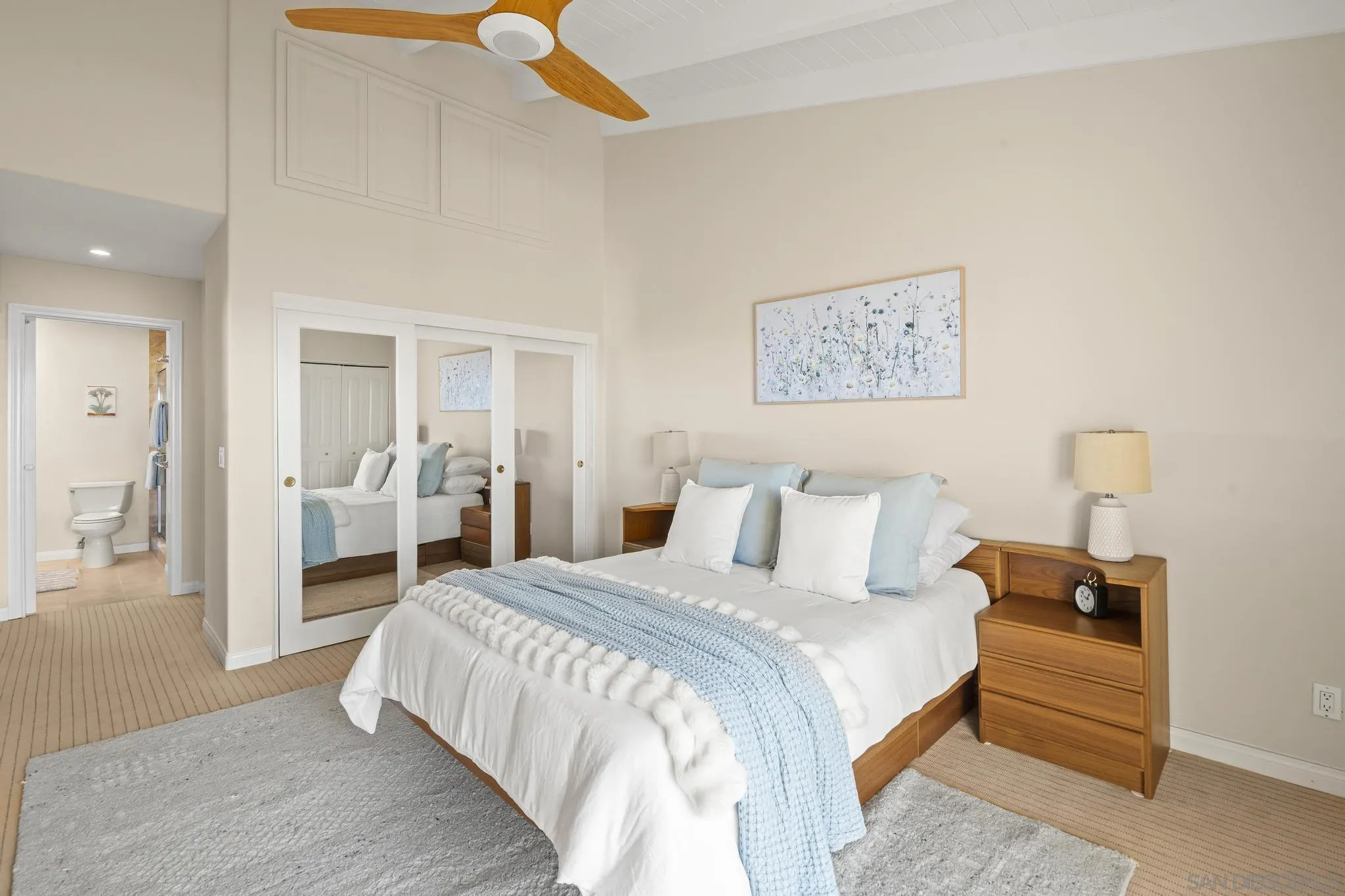 429 South Sierra Avenue, Unit 328 Solana Beach, CA 92075 - Photo 33 of 43 a bedroom with a large bed and a chandelier