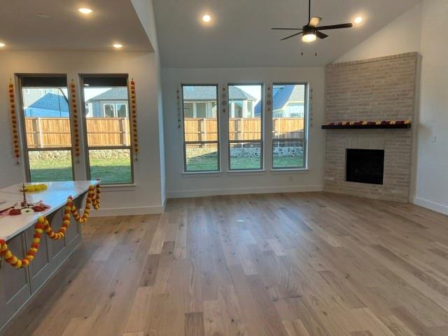 1407 Cartona Road Fate, TX 75087 - Photo 4 of 21 Open-concept living space featuring wood-finish flooring, a vaulted ceiling, and recessed lighting