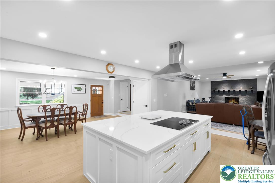 2011 Greenwood Road Allentown, PA 18103 - Photo 17 of 52 An open-concept living space integrates a crisp kitchen island with a spacious dining area and inviting family room, all under recessed lighting.