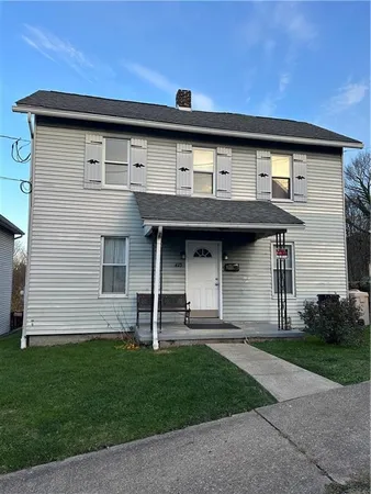 a front view of a house with a garden