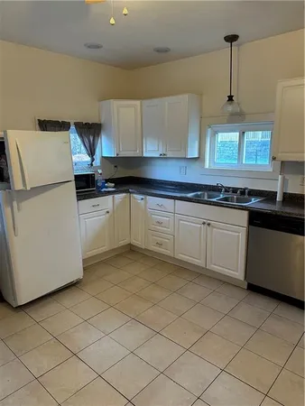 a kitchen with a sink a stove and cabinets