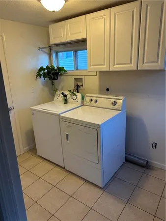 a utility room with a sink washer and dryer
