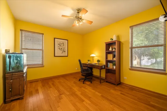 a view of a workspace with furniture and a window