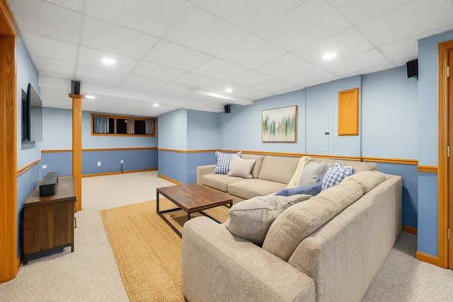 a living room with furniture and kitchen view
