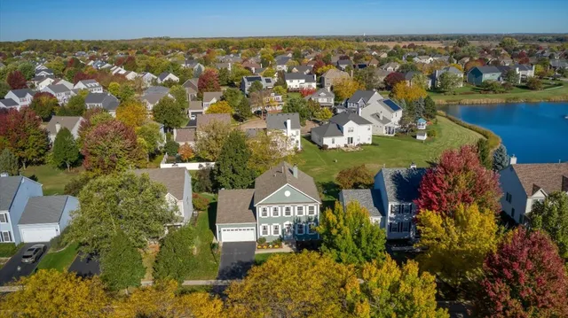 an aerial view of a house with a yard basket ball court and outdoor seating