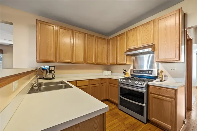 a kitchen with a sink stove top oven and cabinets