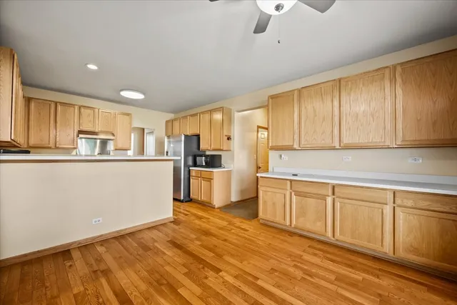 a kitchen with white cabinets stainless steel appliances and sink