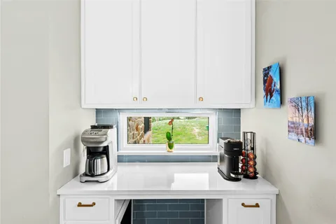 a kitchen with a sink a stove and cabinets