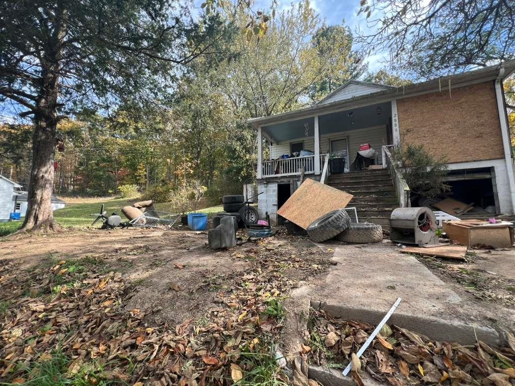 a view of a patio with furniture and a fire pit