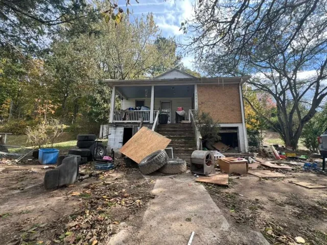 a view of a house with backyard couches and a fire pit