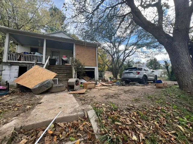 a view of a backyard with table and chairs under an umbrella