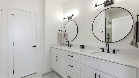 a bathroom with a double vanity sink and a mirror