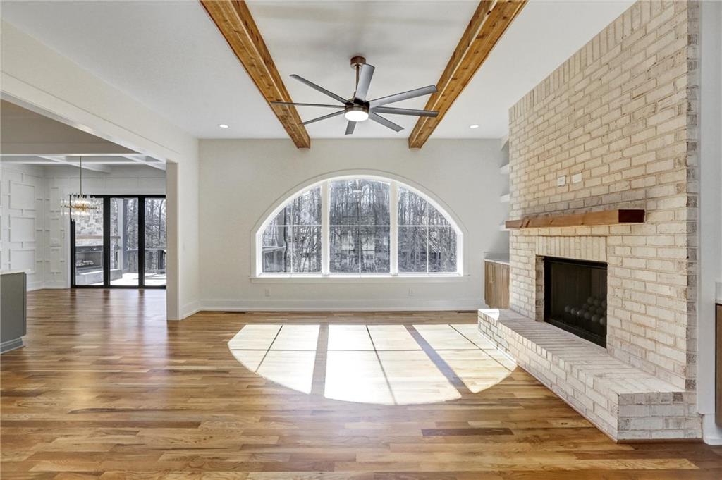 6113 Deepwater Cove Gainesville, GA 30506 - Photo 11 of 82 a view of an empty room with wooden floor and a fireplace