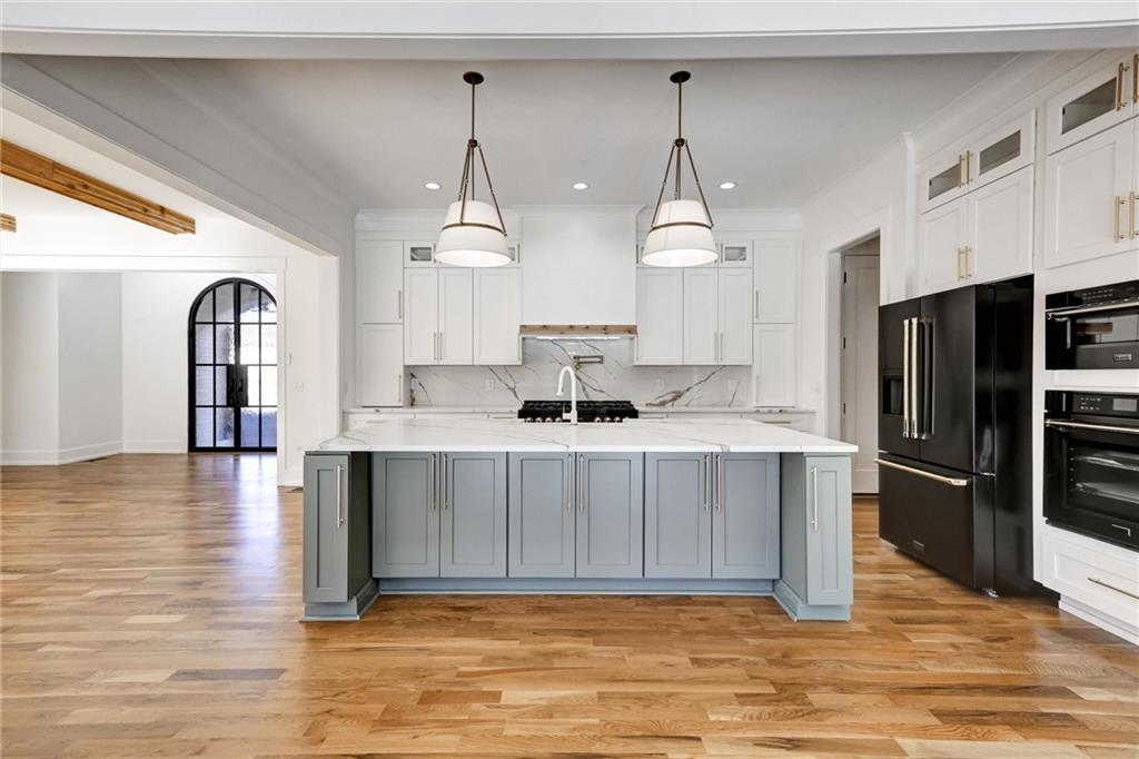 6113 Deepwater Cove Gainesville, GA 30506 - Photo 13 of 82 a kitchen with stainless steel appliances granite countertop a sink refrigerator and cabinets