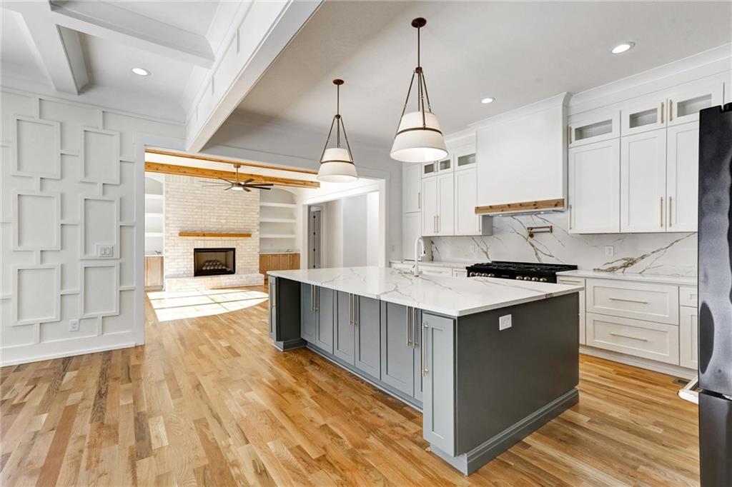6113 Deepwater Cove Gainesville, GA 30506 - Photo 15 of 82 a kitchen with granite countertop a stove and a wooden floors