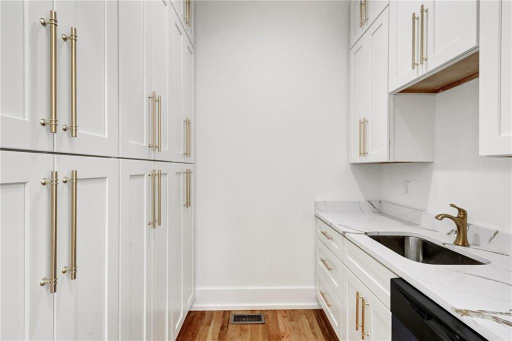 6113 Deepwater Cove Gainesville, GA 30506 - Photo 19 of 82 a kitchen with white cabinets and sink